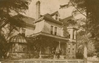 Sepia toned photograph of five girls standing on the front steps of a very large Victorian hous…