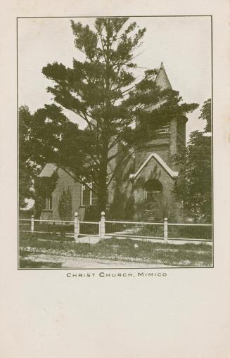 Black and white photograph of a brick church with a bell tower.