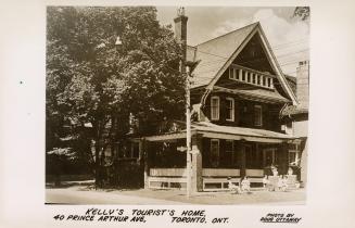 Sepia-toned postcard depicting an image of a home being used for tourist lodging. The caption a…