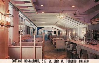 Colour photo postcard depicting the inside of a restaurant with caption at the bottom of the ca…