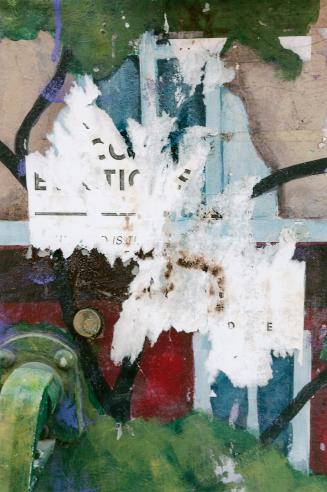 A close-up photograph of a surface covered in posters and graffiti. Portions of posters, some o ...