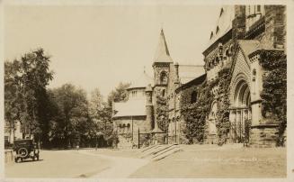 Picture of university building with car in driveway on left. 