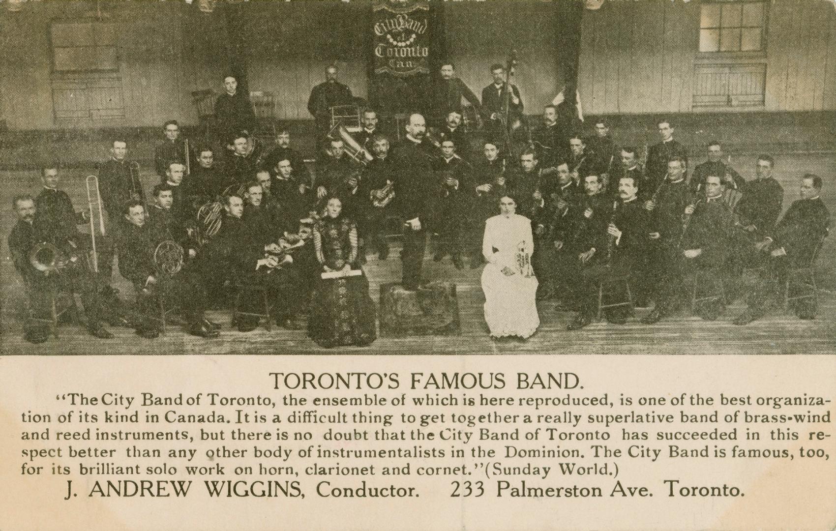 Black and white photograph of a large orchestra, all male with two ladies sitting at the front.