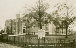 Black/white postcard depicting the exterior of Oakwood Highschool in Toronto. Caption states, "…