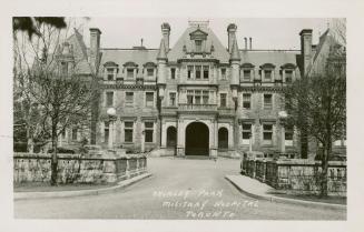 Black and white photograph of a very large mansion in the French Loire Chateau style. 