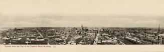 Black and white photograph of a large city taken from a position many stories up a skyscraper.