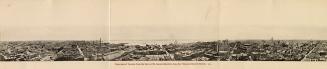 Black and white photograph of a large city taken from a position many stories up from street le…