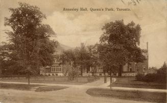 Sepia-toned photo postcard depicting a building with a circular driveway, with caption at the t…