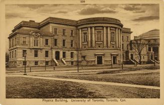 Sepia-toned photo postcard depicting a building with caption at the bottom stating, "Physics Bu…