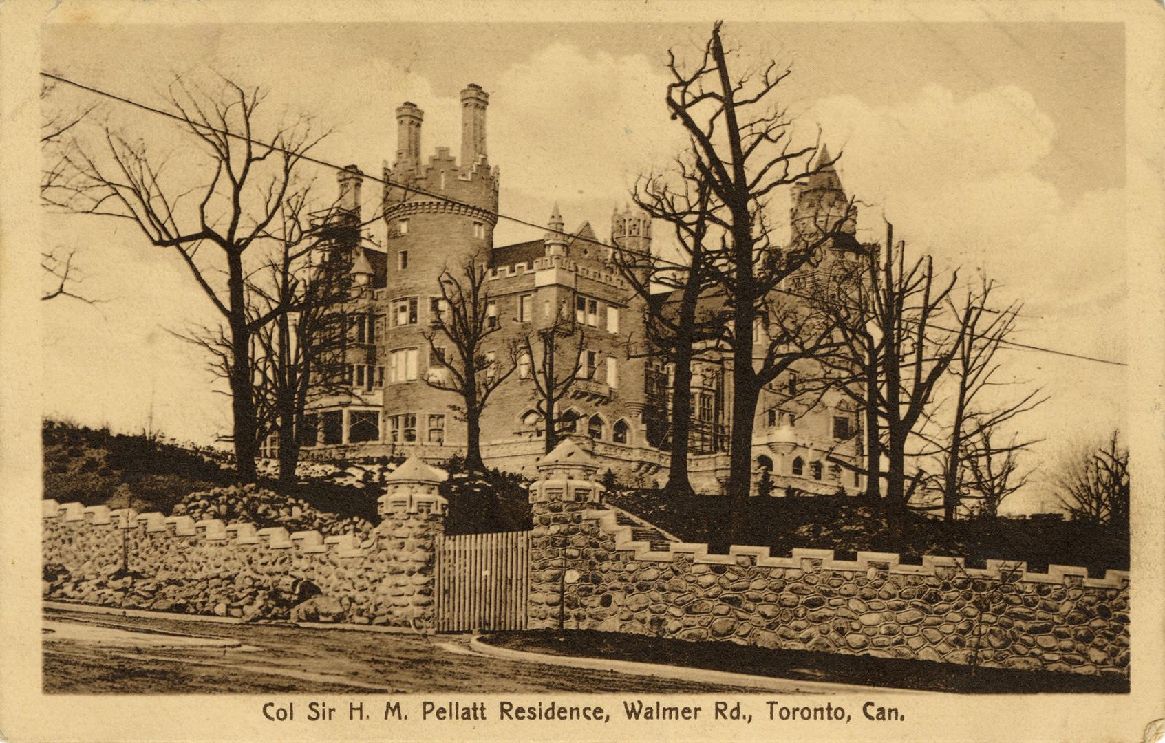 Sepia toned picture of a castle with a stone wall in front of it.