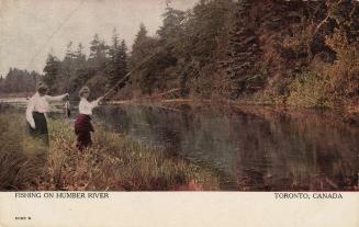 Colorized photograph of two women standing on the bank of a river fishing. One has caught a lar…