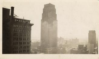 A photograph of a city skyline, with three skyscrapers far taller than the surrounding building ...