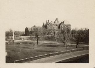 A photograph of a a large building in a Richardson Romanesque style, located in the middle of a…