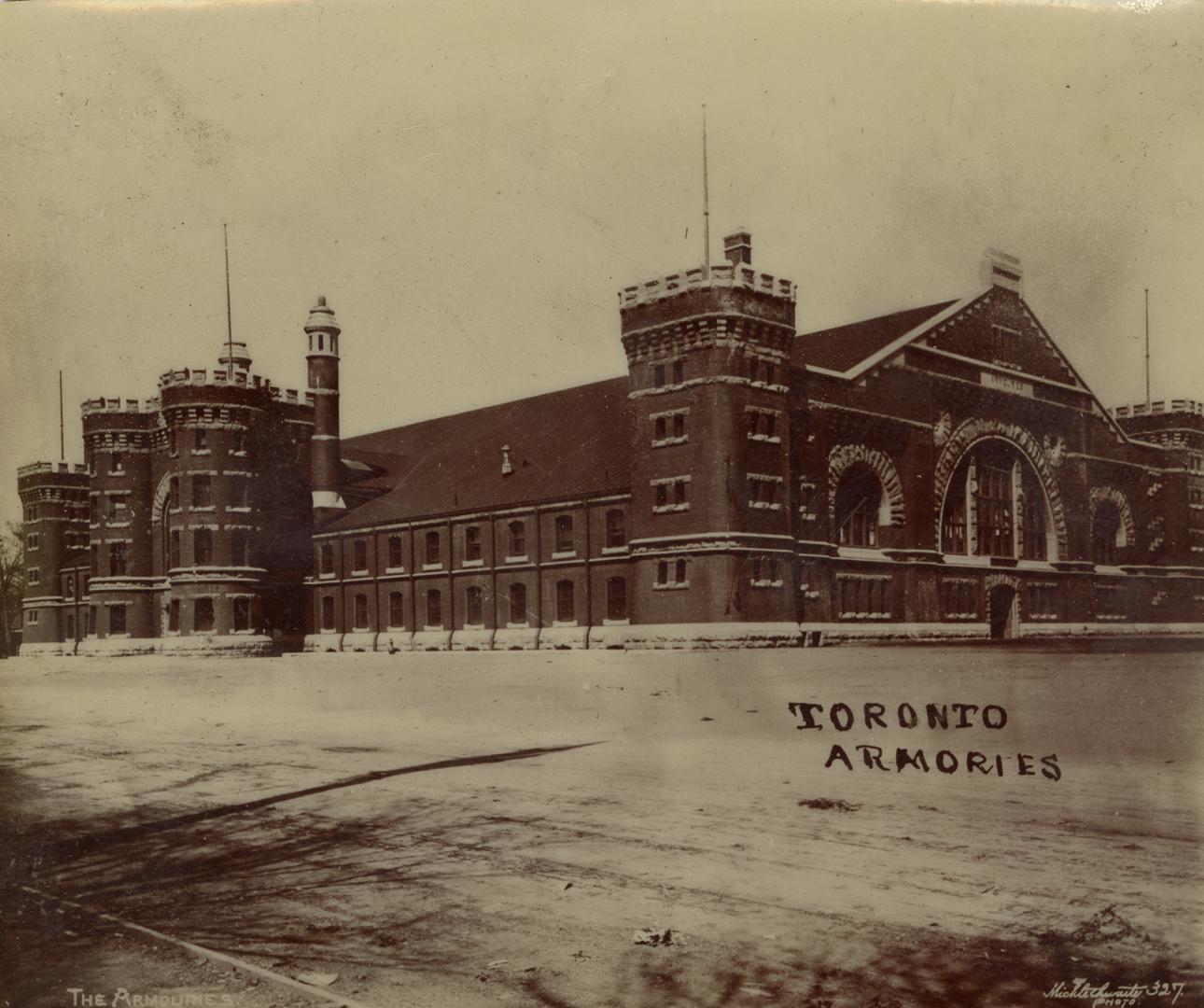 A photograph of a large stone building in a Romanesque Revival style, with towers and castellat ...