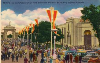 Colorized photograph of a large crowd walking on a pathway with flags and large stone gate in t…