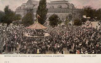 Colorized photograph of a massive crowd standing around an outdoor, circular bandstand with a l…