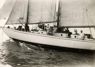 Black and white photograph of a yacht under sail.