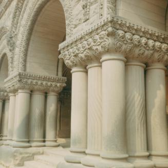 A photograph of two grouping of stone columns with decorative engravings. The engravings includ ...