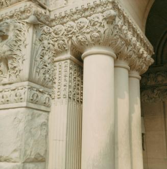 A photograph of a grouping of stone columns with decorative engravings. The engravings include  ...