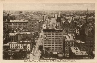 Black and white photograph of an aerial view of a large city downtown area with skyscrapers.