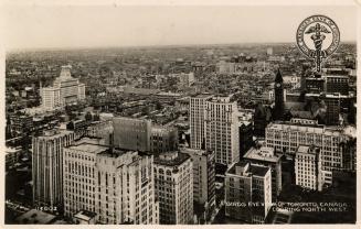 Black and white photograph of an aerial view of a large city downtown area with skyscrapers.