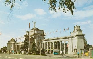 Color photograph of a large, neoclassical archway made of cement and stone.