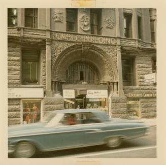 A photograph of a stone building with an arched entranceway and the words "TEMPLE BUILDING" eng ...