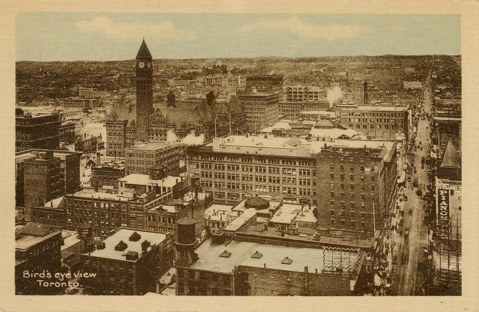 Black and white photograph taken from the air of a major city street. The sky has been colored …