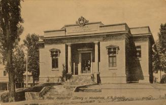 Picture of one storey brick and grey stone library building. 