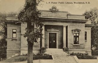 Picture of one storey brick and grey stone library building. 