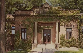 Picture of one storey brick and grey stone library building. 