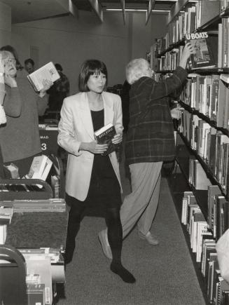 Picture of group of people shelving library books.