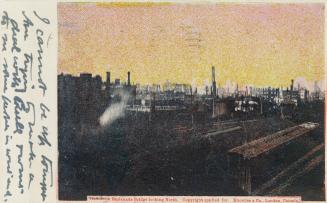 Colour postcard depicting a distant view of the damage from the 1904 fire of Toronto amid a red…