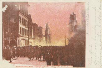 Colour postcard depicting a large crowd on Bay St. looking south towards the 1904 fire of Toron…