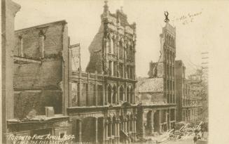 Black and white photo postcard depicting a row of buildings damaged by the 1904 fire of Toronto…