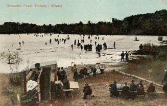 Colorized photograph of many people walking on a frozen pond with people sitting on the shoreli…