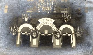 A photograph of the main entrance to a city hall, decorated with bunting, flags of the United K…