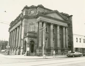 Picture of large stone library with pillars and corner entrance. 