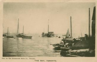 Black and white photo postcard depicting the harbour at the Toronto Canoe Club with boats and c…