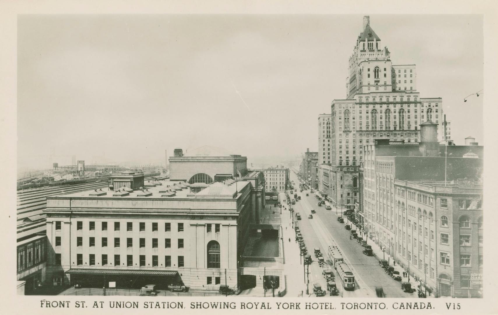 Black and white photo postcard depicting a view of Front Street looking west, with Union statio…