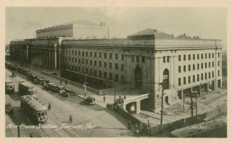 Black and white photo postcard depicting an exterior view of Union station, with the caption st…