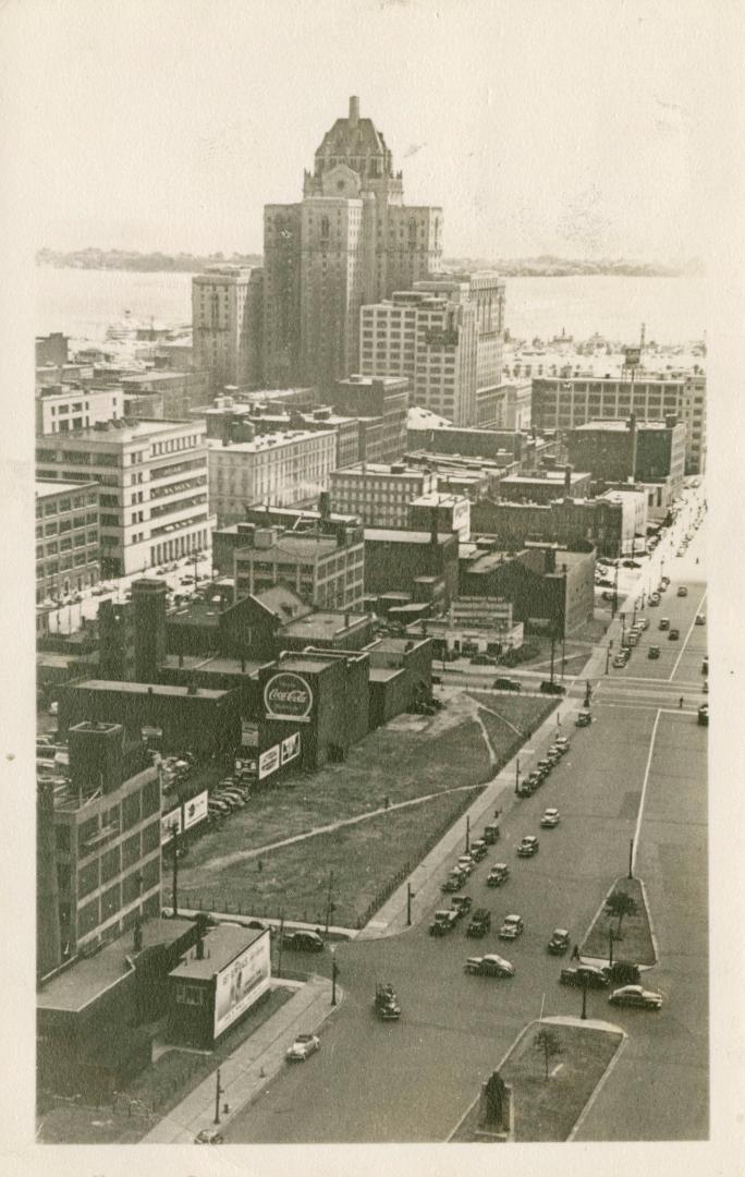 Black and white photo postcard depicting a view of the Royal York Hotel from Queen St. looking …