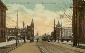 Colorized photograph of automobiles and people and a streetcars traveling on a busy city street…