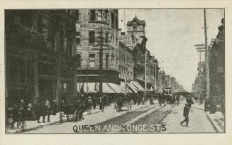 Black and white photograph of a very busy city street corner with automobiles and a streetcar.