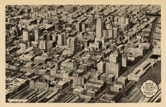 Black and white aerial photograph of a large city with skyscrapers.