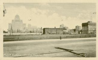 Black and white photo postcard depicting a view looking north from Fleet and York Streets. The …