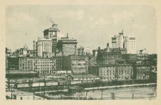 Green-toned photo postcard depicting an illustration of a view of buildings making up Toronto's…