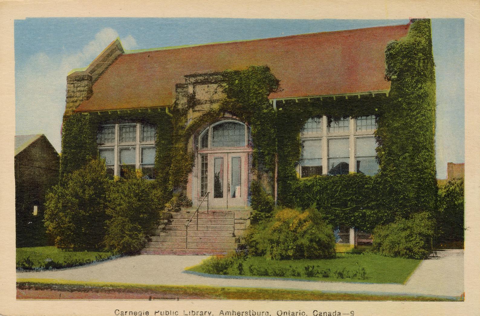 Picture of one store library building covered in ivy. 