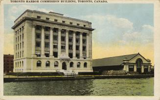 Colorized photograph of a six story building of Beaux-arts architecture resting on the shorelin…