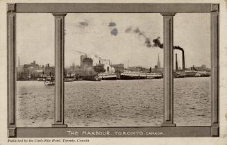 Black and white photograph of a steam boasts sailing in front of busy docks of a large city.